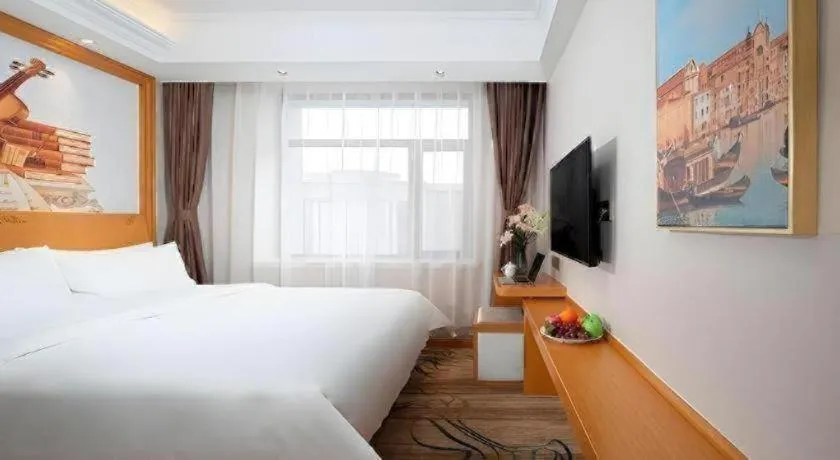 Bed in Vienna Hotel Jilin Dunhua High-Speed Railway Station