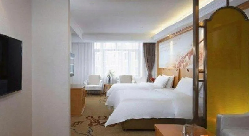Bed in Vienna Hotel Jilin Dunhua High-Speed Railway Station