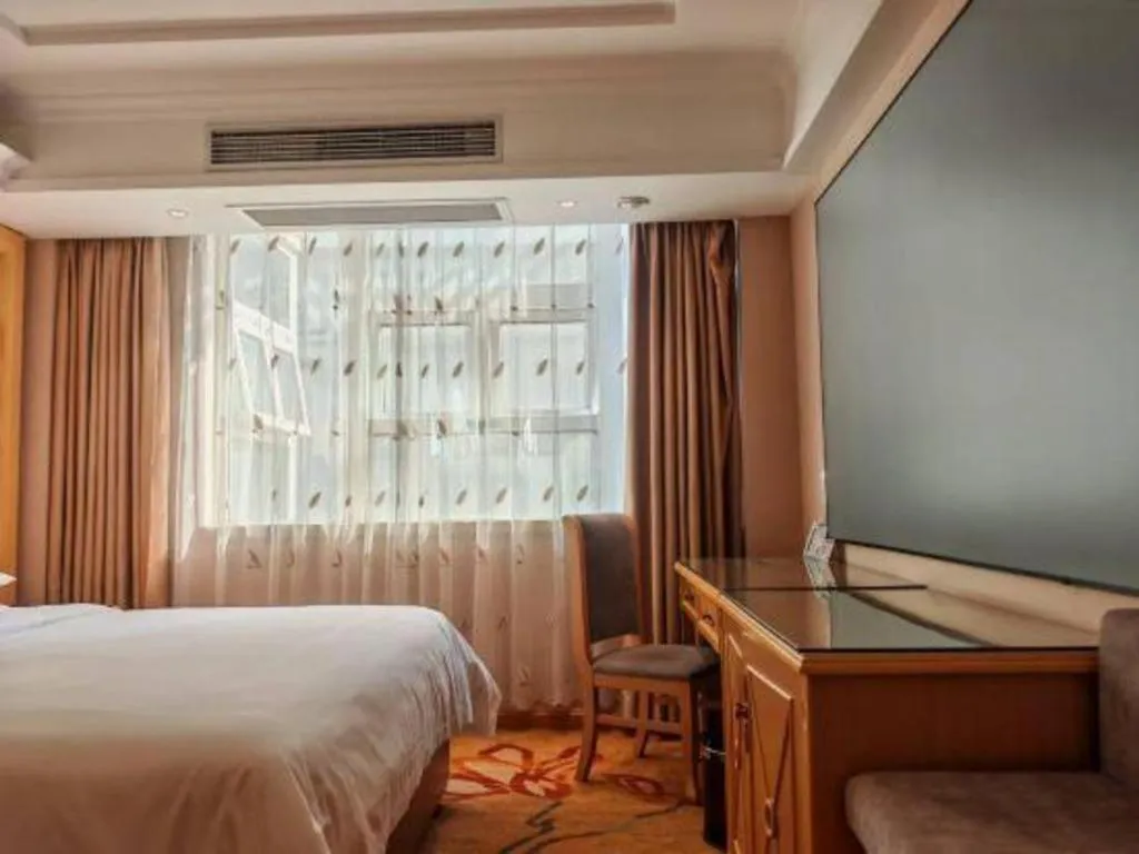 Bed in Vienna Hotel Guangxi Hezhou Guposhan Suifeng