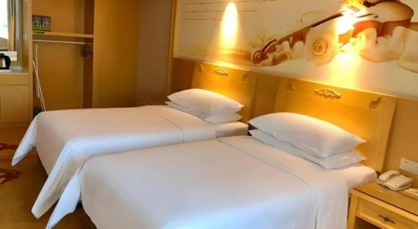 Bed in Vienna Hotel Guangxi Hezhou Guposhan Suifeng