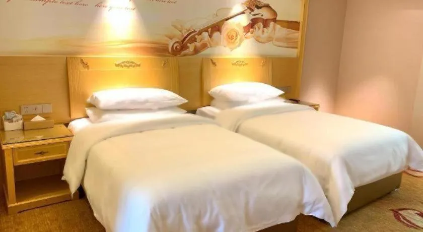 Bed in Vienna Hotel Guangxi Hezhou Guposhan Suifeng