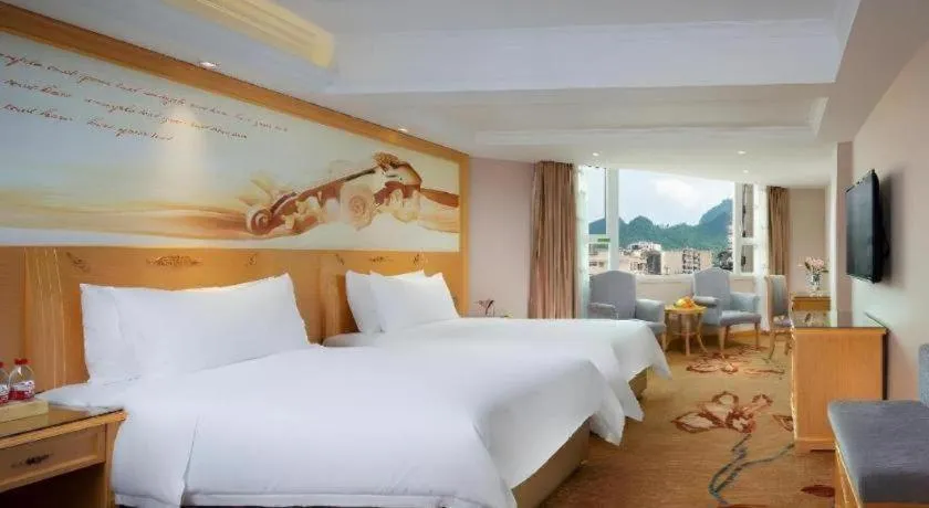 Bed in Vienna Hotel Guangxi Hezhou Guposhan Suifeng