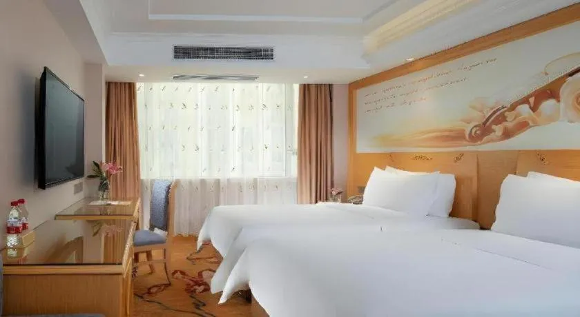 Bed in Vienna Hotel Guangxi Hezhou Guposhan Suifeng