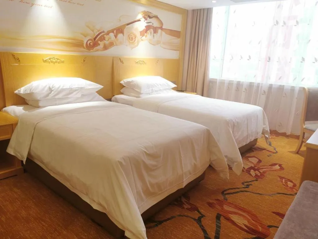 Bed in Vienna Hotel Guangxi Hezhou Guposhan Suifeng