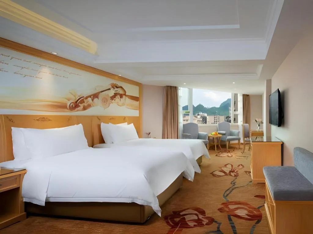 Bed in Vienna Hotel Guangxi Hezhou Guposhan Suifeng