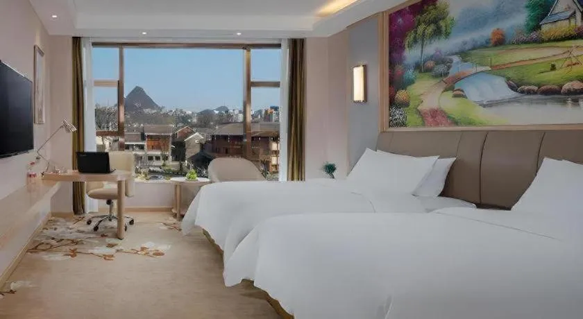 Bed in Vienna Hotel Guizhou Liupanshui Shuicheng Ancient Town