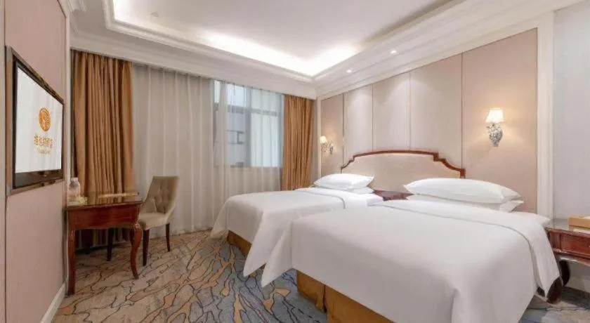 Bed in Vienna Hotel Guangzhou Baiyun College Jinyuan Plaza