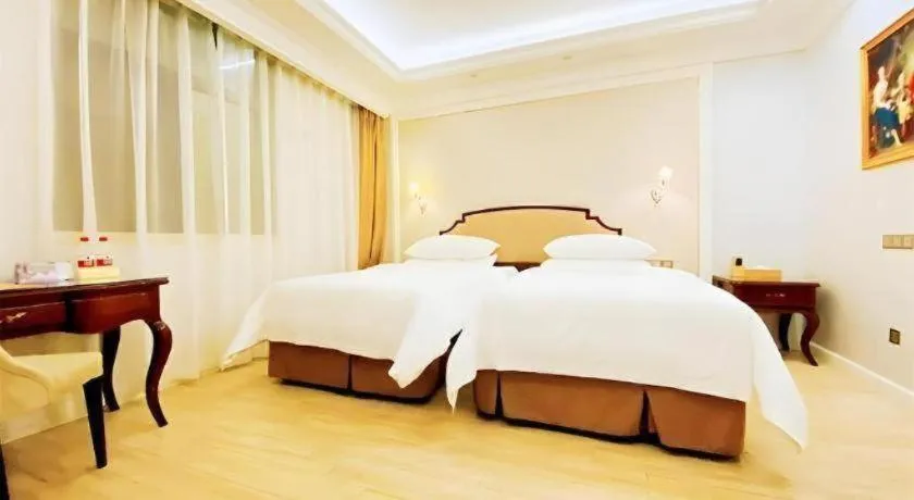 Bed in Vienna Hotel Guangzhou Baiyun College Jinyuan Plaza