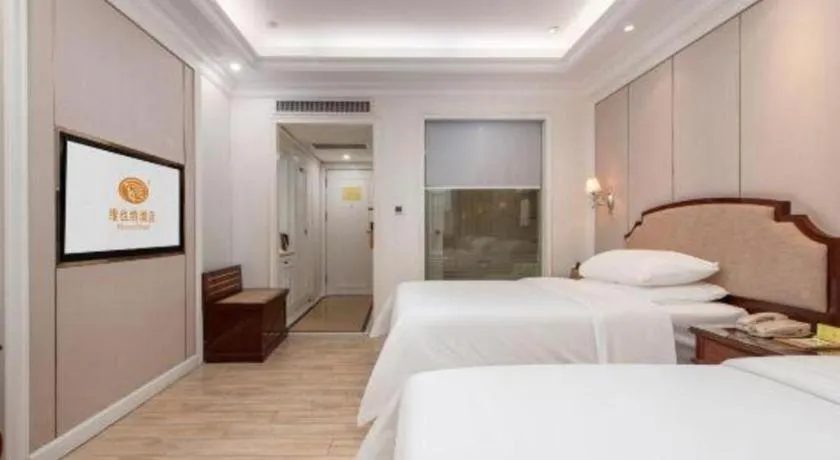 Bed in Vienna Hotel Guangzhou Baiyun College Jinyuan Plaza