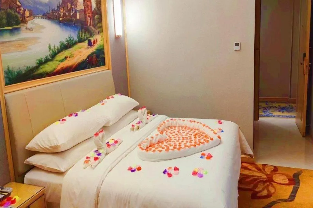 Bed in Vienna Hotel Guangxi Hechi Jinchengjiang Baima Street
