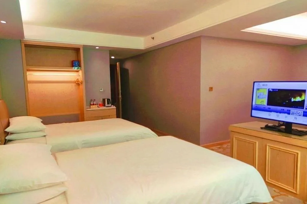 Bed in Vienna Hotel Guangxi Hechi Jinchengjiang Baima Street