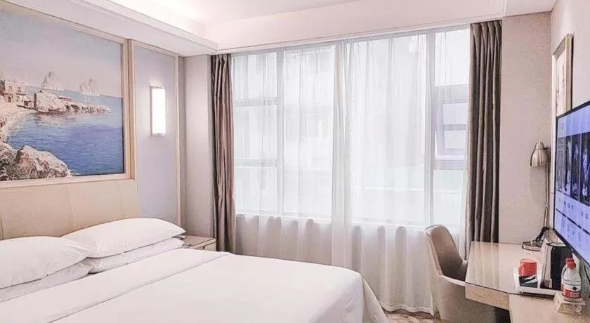 Bed in Vienna Hotel Guangxi Hechi Jinchengjiang Baima Street