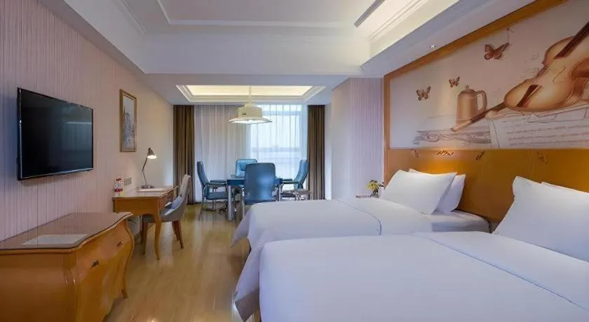 Bed in Vienna Hotel Guangdong Meizhou Fengshun