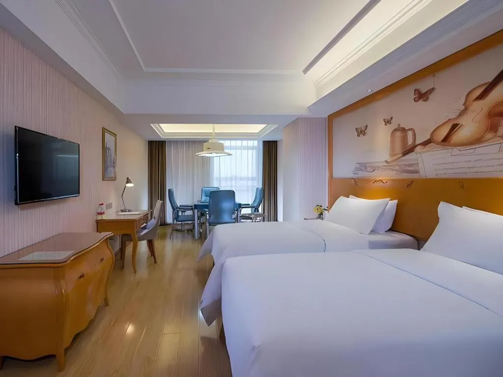Bed in Vienna Hotel Guangdong Meizhou Fengshun