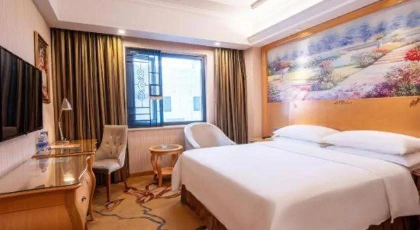 Bed in Vienna Hotel Guangdong Meizhou Fengshun