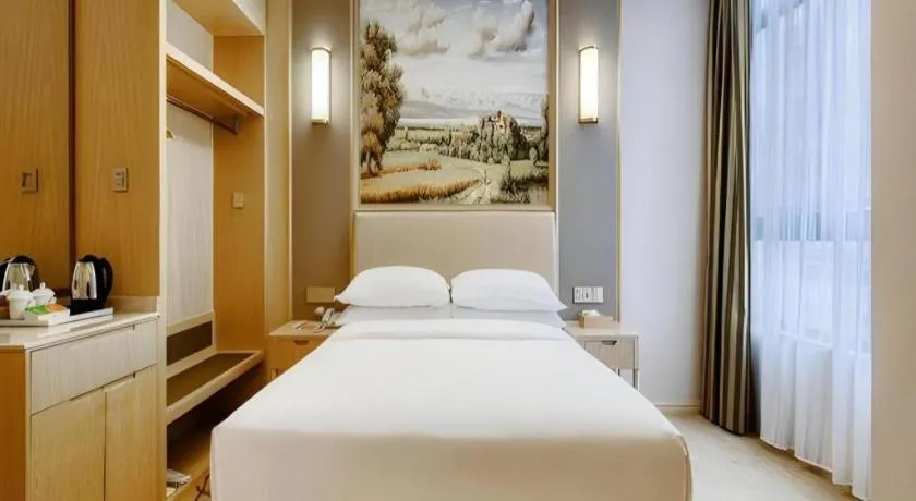 Bed in Vienna Hotel Fujian Fuqing Wanda Plaza