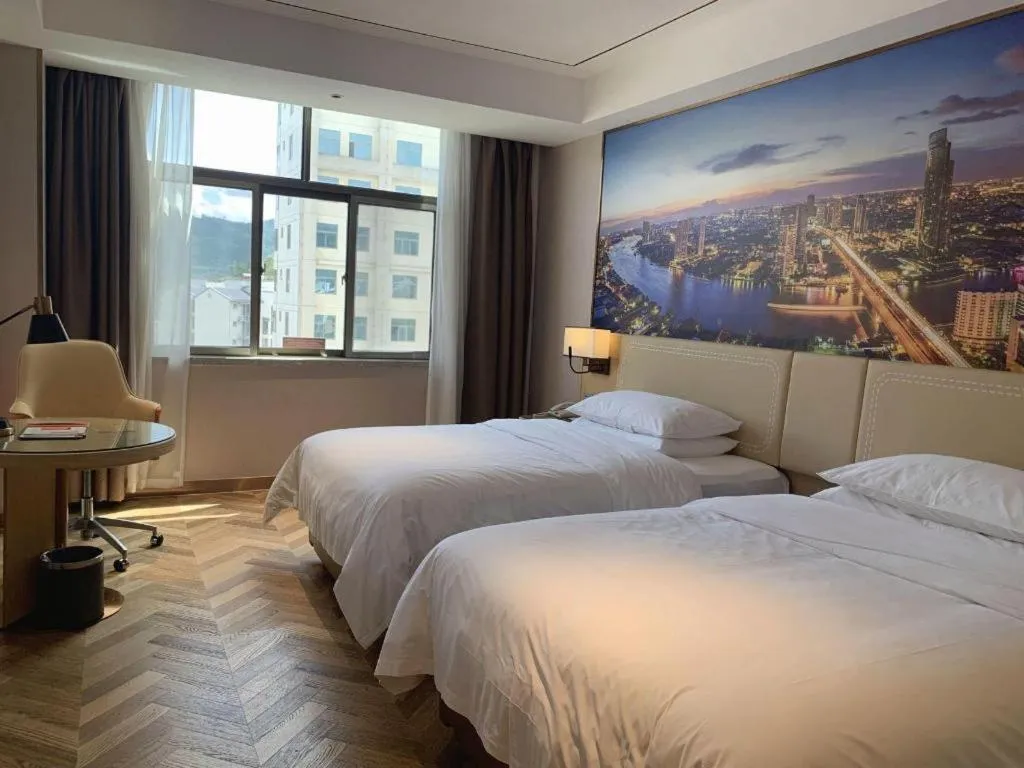 Bed in Vienna Hotel Guangxi Baise Xilin County Juting Cultural Arts Center