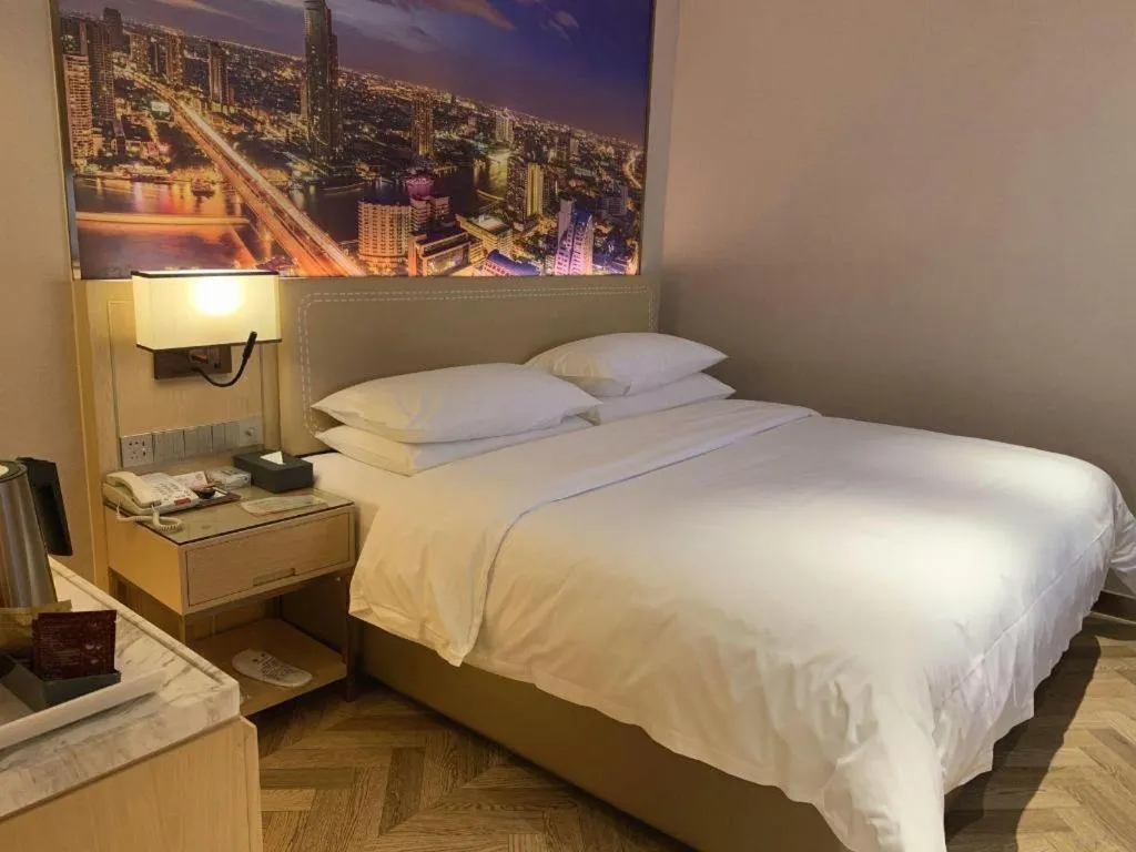 Bed in Vienna Hotel Guangxi Baise Xilin County Juting Cultural Arts Center