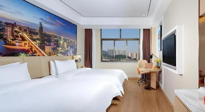 Bed in Vienna Hotel Guangxi Baise Xilin County Juting Cultural Arts Center