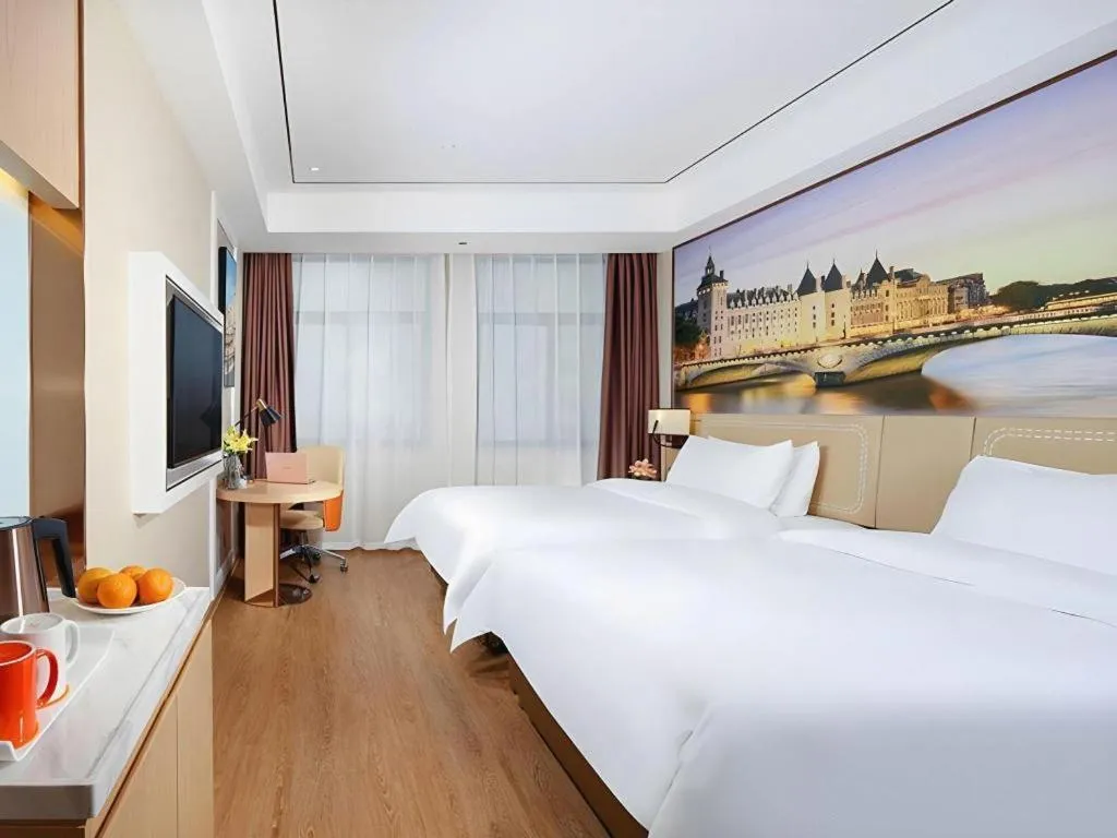 Bed in Vienna Hotel Guangxi Baise Xilin County Juting Cultural Arts Center