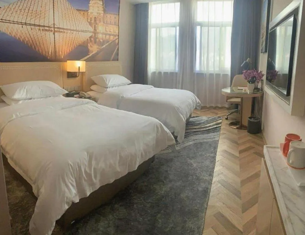 Bed in Vienna Hotel Guangxi Baise Xilin County Juting Cultural Arts Center