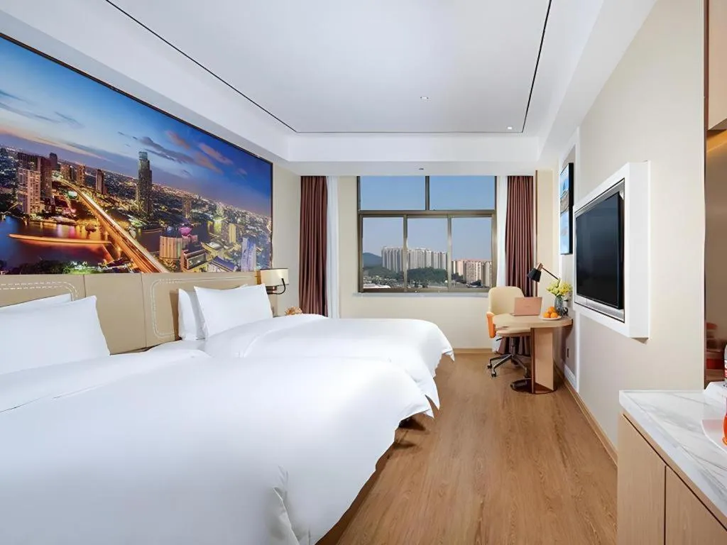 Bed in Vienna Hotel Guangxi Baise Xilin County Juting Cultural Arts Center