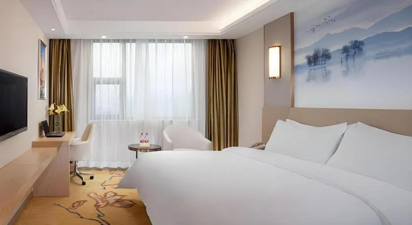 Bed in Vienna Hotel Guangxi Wuzhou High-Tech