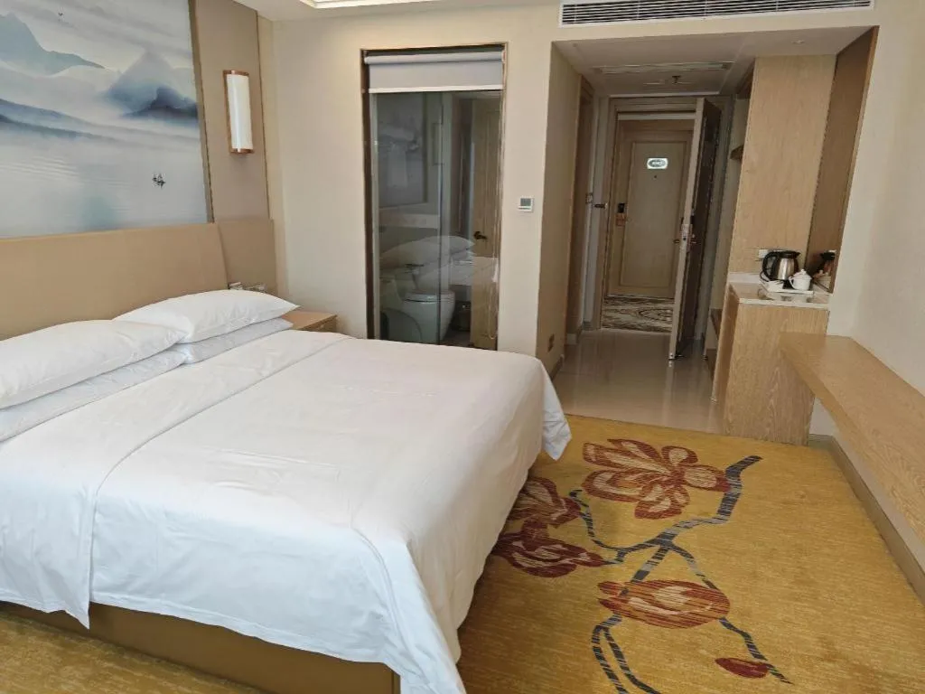 Bed in Vienna Hotel Guangxi Wuzhou High-Tech