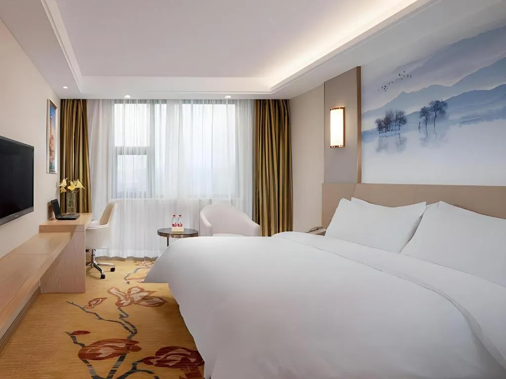 Bed in Vienna Hotel Guangxi Wuzhou High-Tech