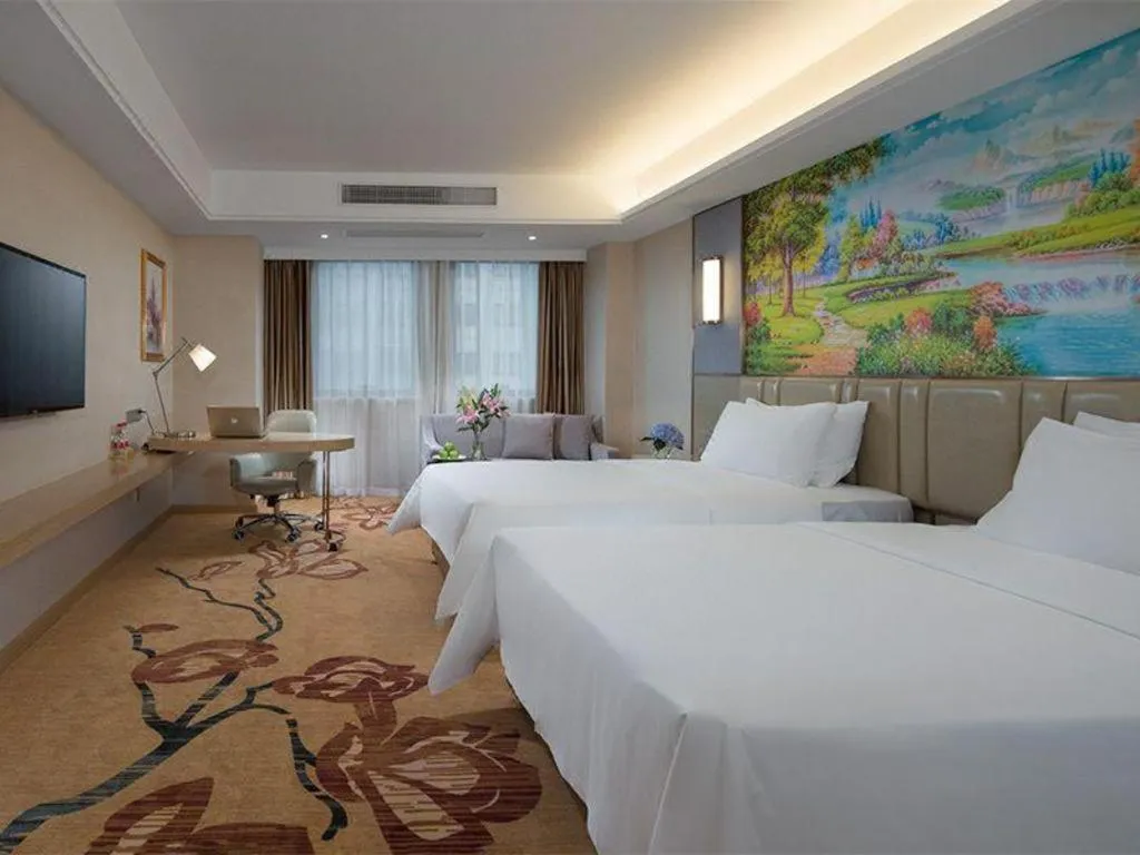 Bed in Vienna Hotel Guangxi Wuzhou High-Tech