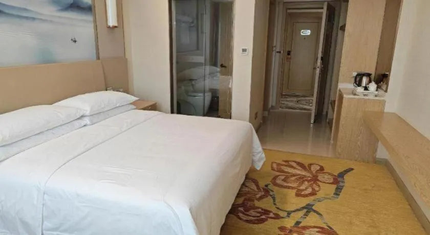 Bed in Vienna Hotel Guangxi Wuzhou High-Tech