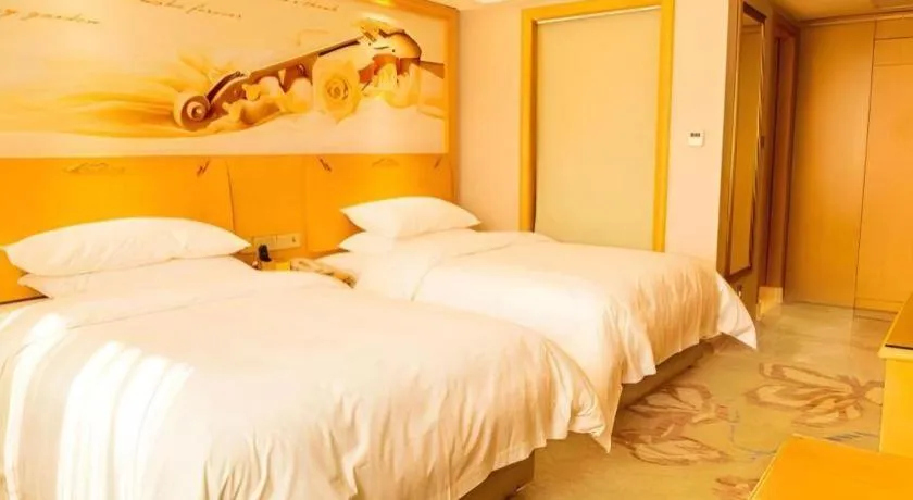 Bed in Vienna Hotel Guangdong Shaoguan Ruyuan Yao Cultural Square