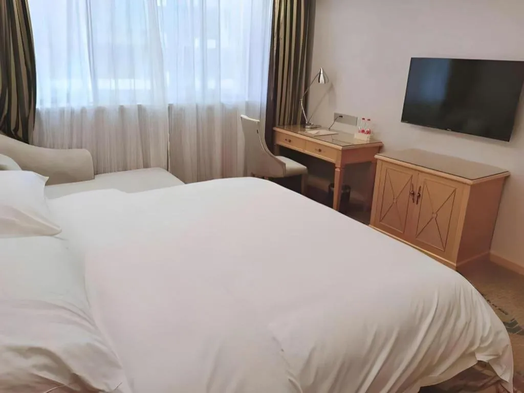 Bed in Vienna Hotel Guangdong Shaoguan Ruyuan Yao Cultural Square
