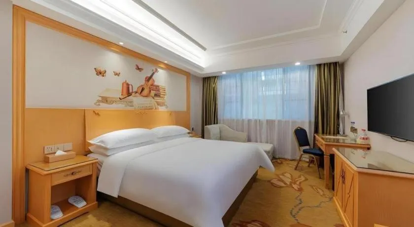 Bed in Vienna Hotel Guangdong Shaoguan Ruyuan Yao Cultural Square
