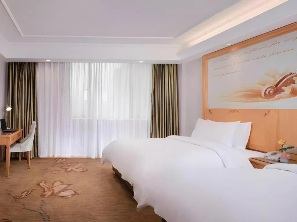 Bed in Vienna Hotel Guangdong Shaoguan Ruyuan Yao Cultural Square