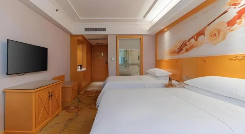 Bed in Vienna Hotel Guangdong Shaoguan Ruyuan Yao Cultural Square