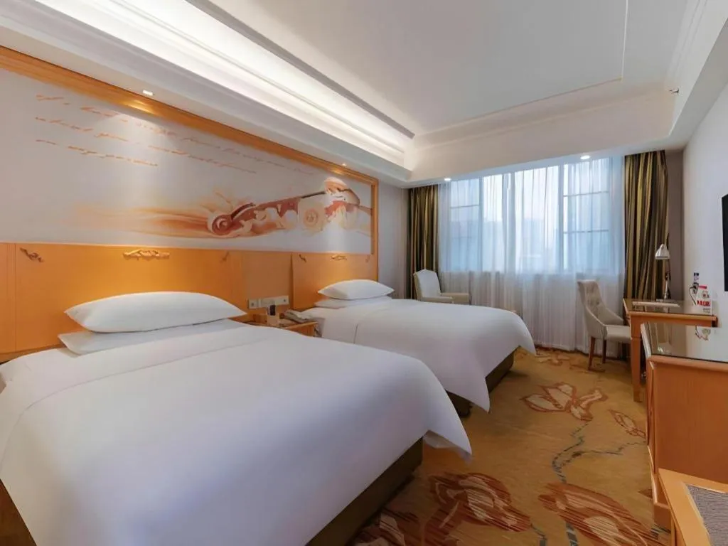 Bed in Vienna Hotel Guangdong Shaoguan Ruyuan Yao Cultural Square