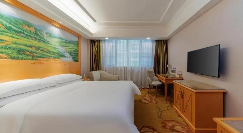 Bed in Vienna Hotel Guangdong Shaoguan Ruyuan Yao Cultural Square