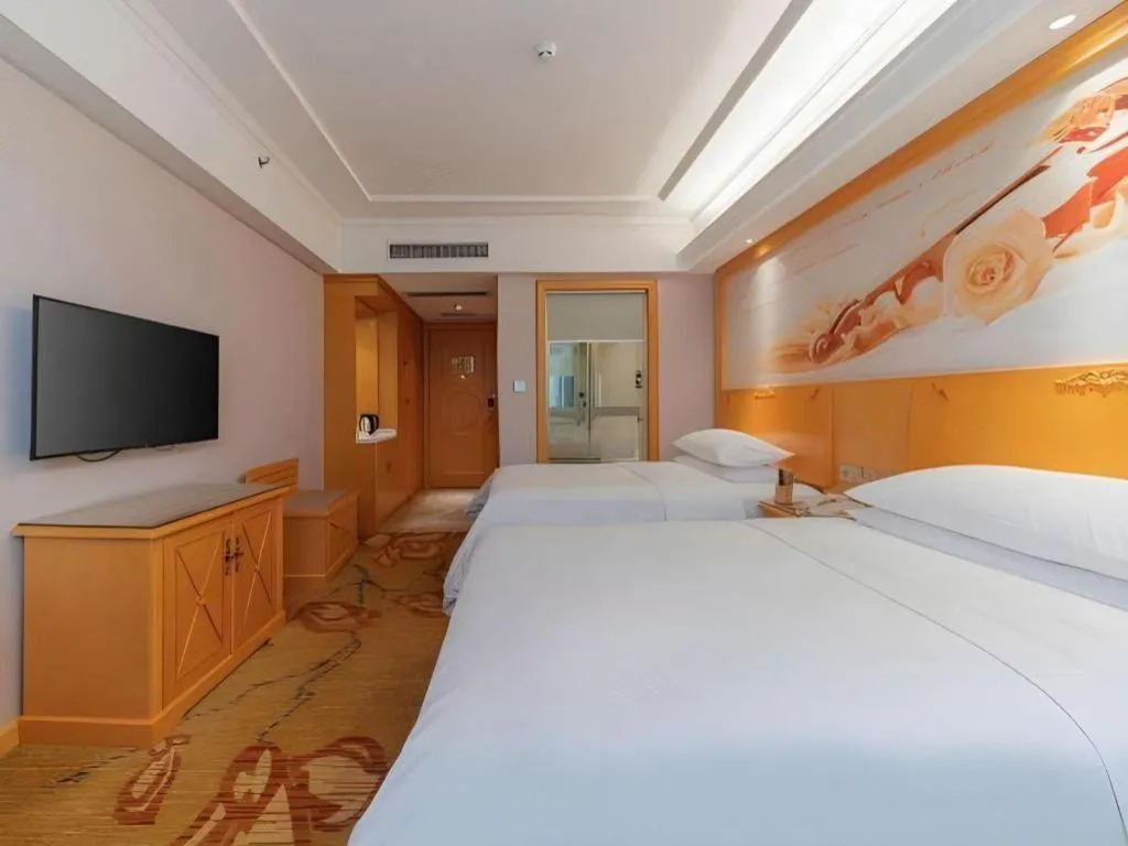 Bed in Vienna Hotel Guangdong Shaoguan Ruyuan Yao Cultural Square