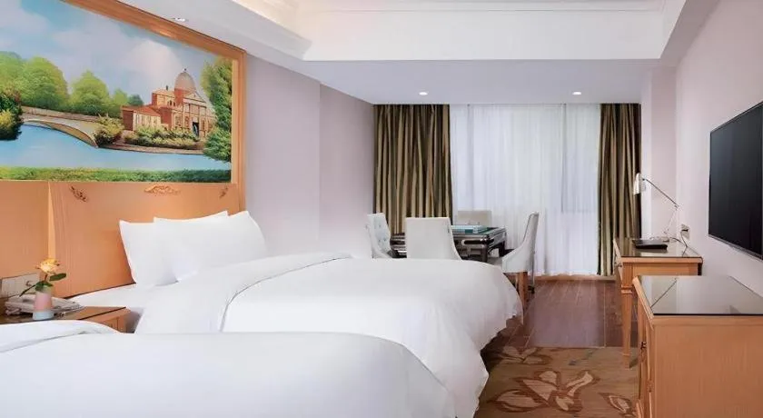 Bed in Vienna Hotel Guangdong Shaoguan Ruyuan Yao Cultural Square