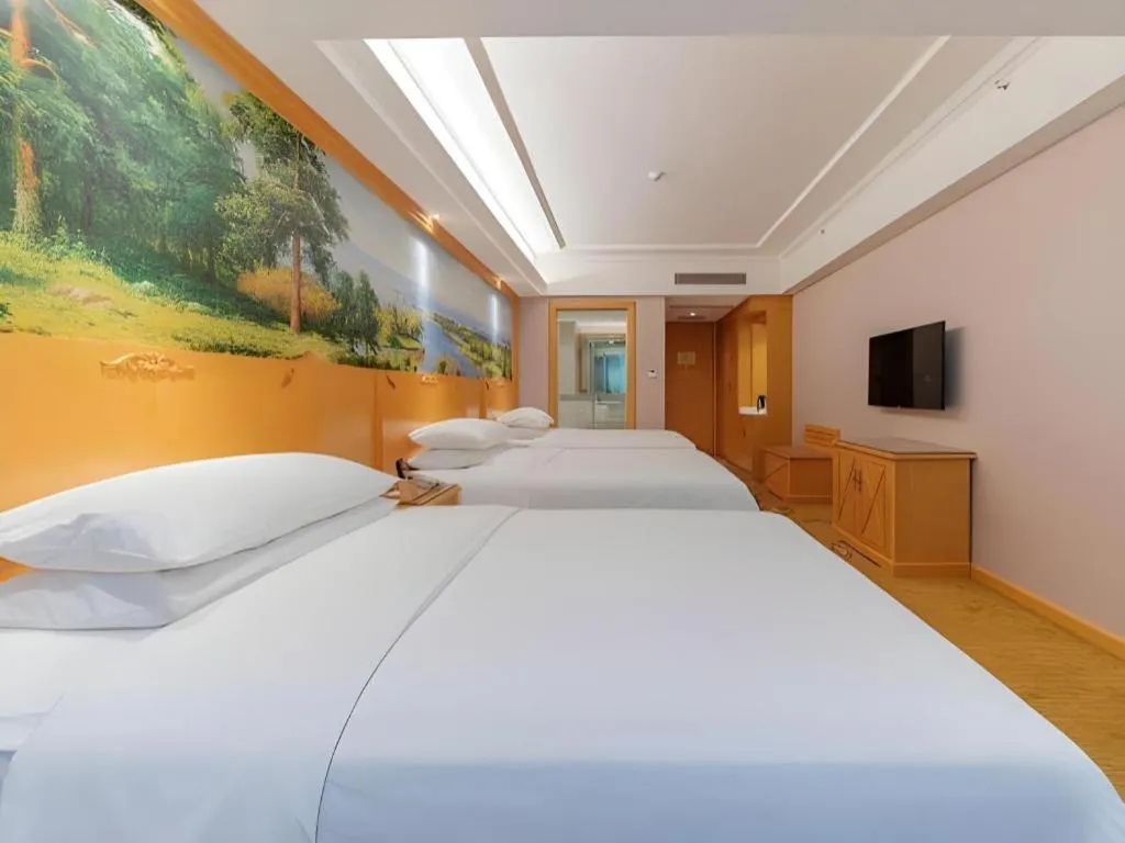 Bed in Vienna Hotel Guangdong Shaoguan Ruyuan Yao Cultural Square