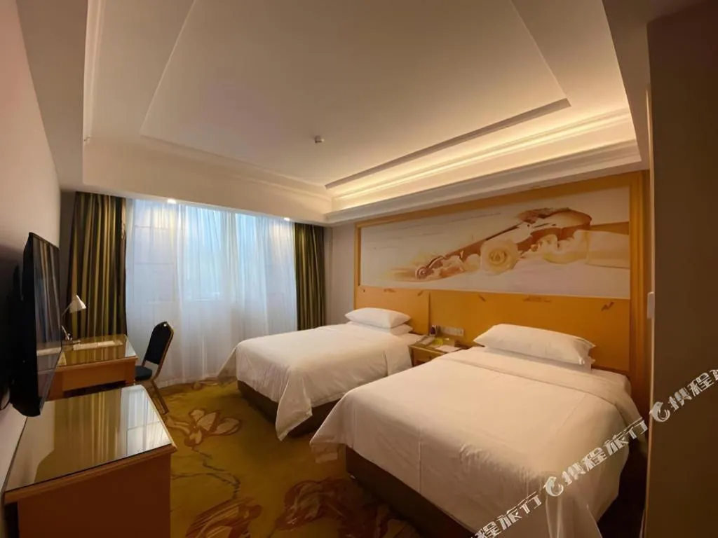 Bed in Vienna Hotel Guangdong Shaoguan Ruyuan Yao Cultural Square