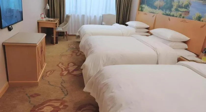 Bed in Vienna Hotel Guangdong Shaoguan Ruyuan Yao Cultural Square