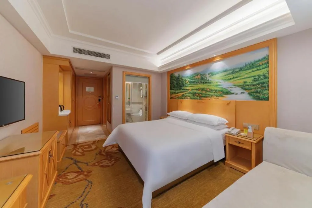 Bed in Vienna Hotel Guangdong Shaoguan Ruyuan Yao Cultural Square