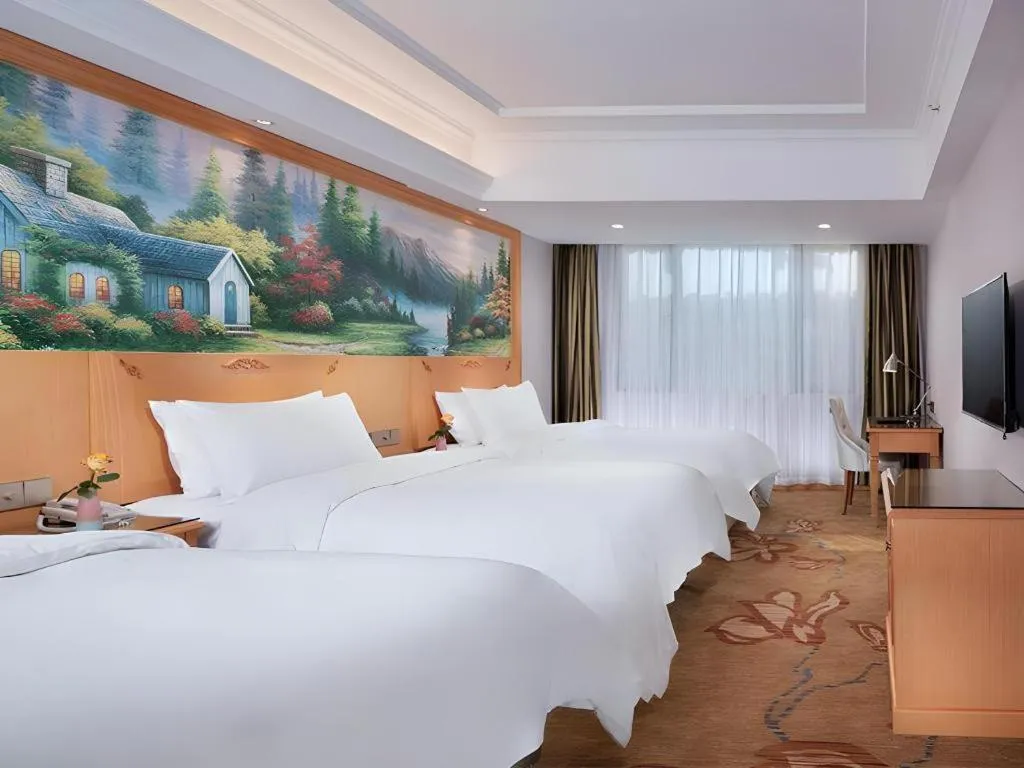 Bed in Vienna Hotel Guangdong Shaoguan Ruyuan Yao Cultural Square