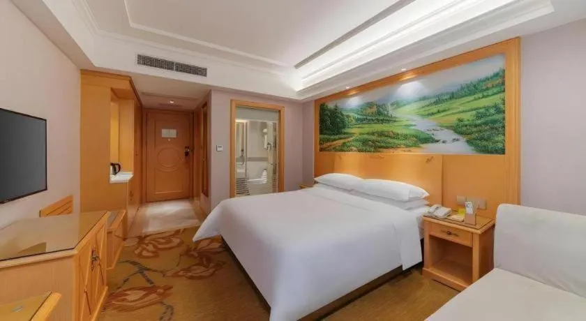 Bed in Vienna Hotel Guangdong Shaoguan Ruyuan Yao Cultural Square