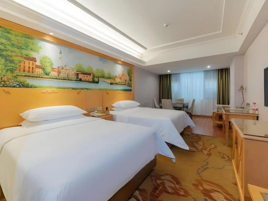 Bed in Vienna Hotel Guangdong Shaoguan Ruyuan Yao Cultural Square