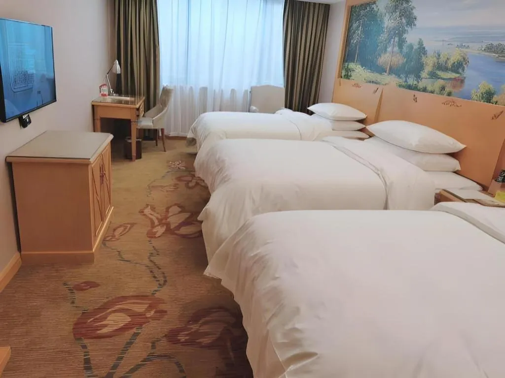 Bed in Vienna Hotel Guangdong Shaoguan Ruyuan Yao Cultural Square