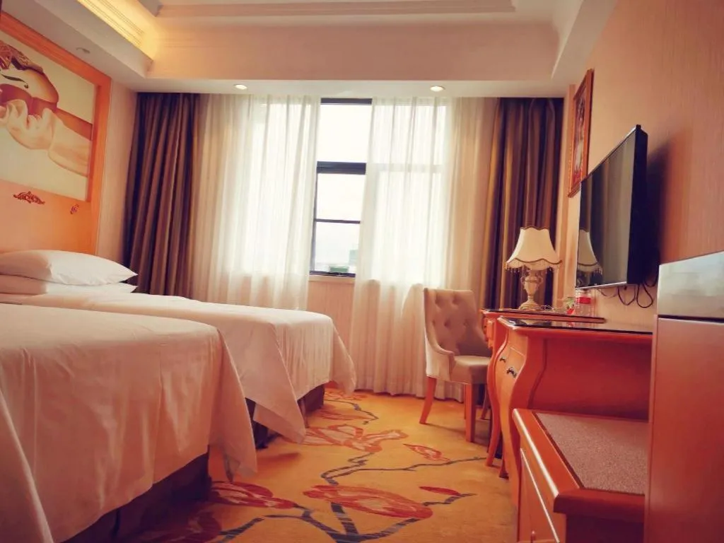 Bed in Vienna Hotel Guangxi Beiliu Passenger Station