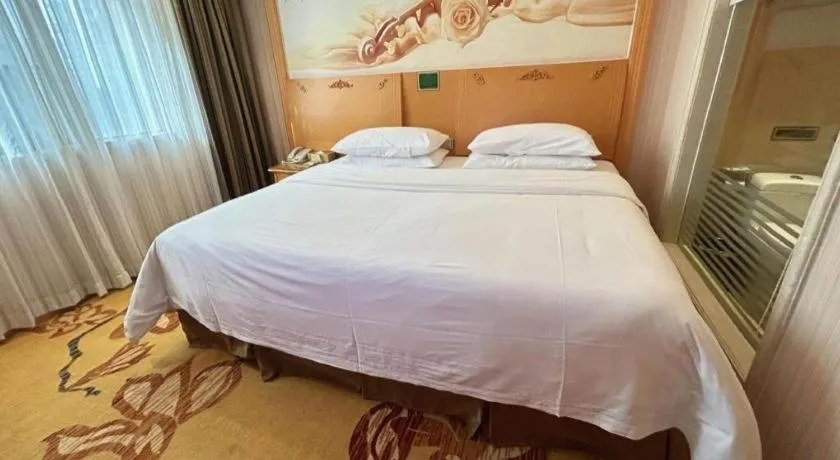 Bed in Vienna Hotel Guangxi Beiliu Passenger Station